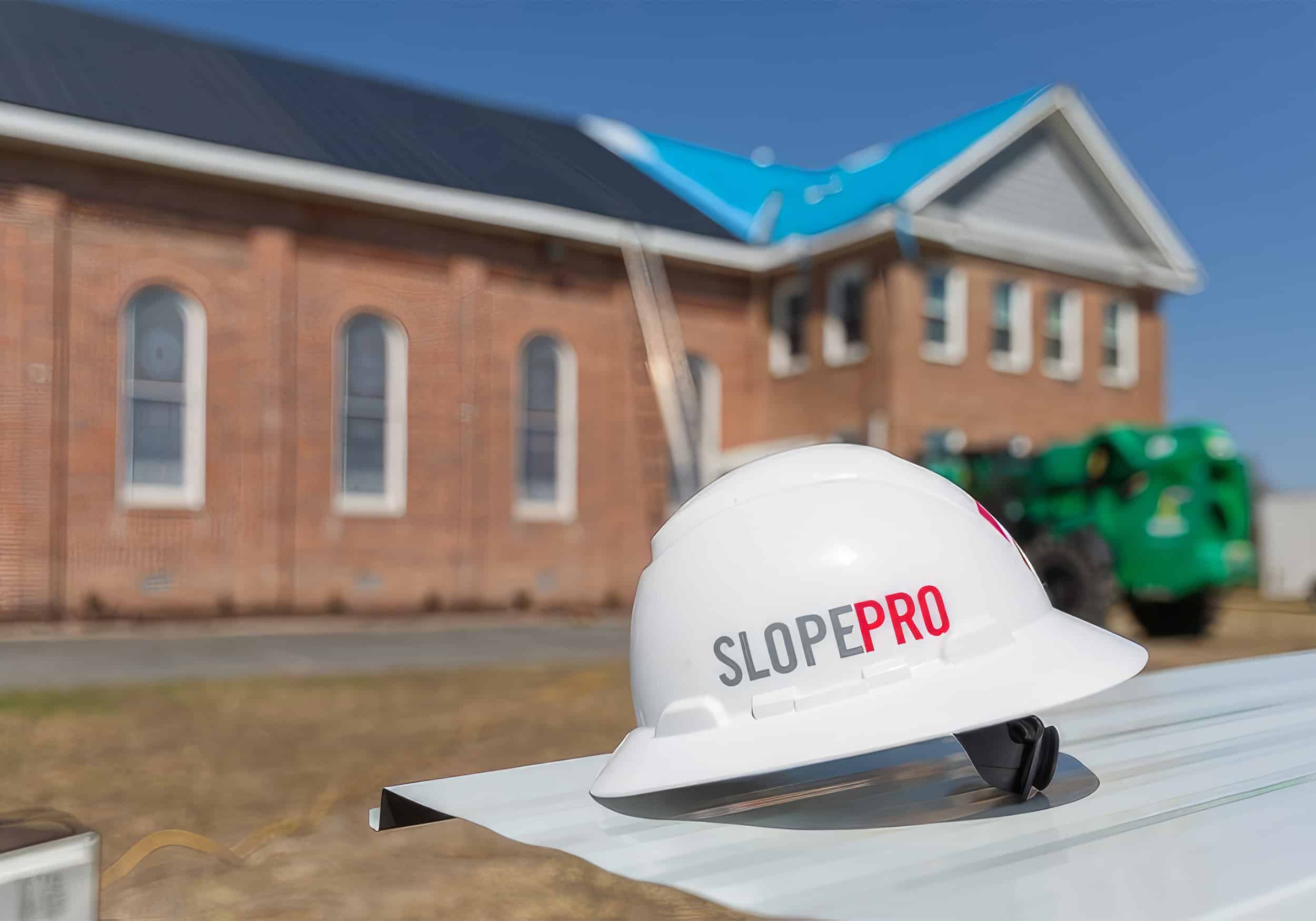 Commercial roof repair with SlopePro helmet in the foreground